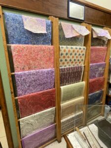 Colorful marbelized paper hanging from wooden hanger