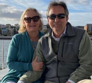 Margaret and her husband smiling in the sunshine